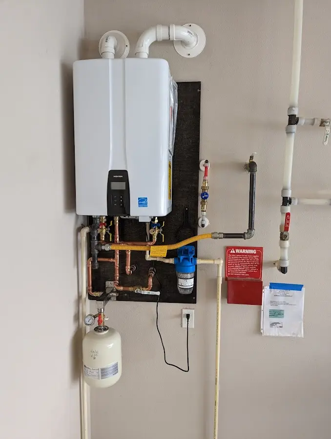 Professional plumber installing copper piping in a Bloomfield Hills home